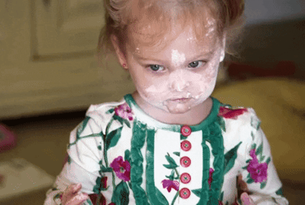 gif of child covered in white powder all over face