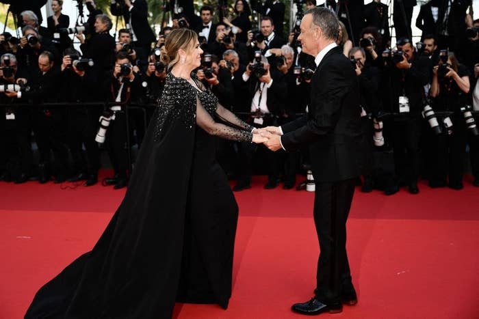 Rita Wilson and Tom Hanks holding hands on the red carpet