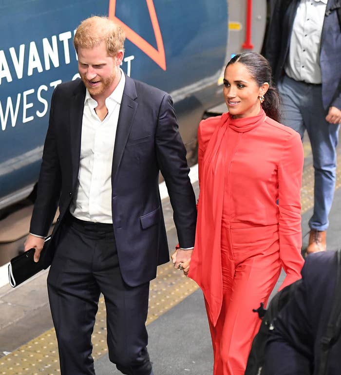 The couple walking outside hand-in-hand