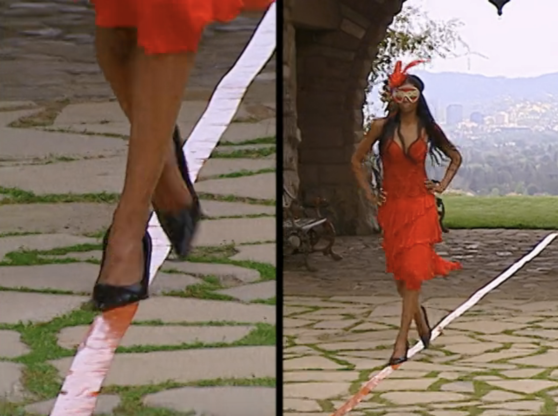 A contestant walks on cobblestone in heels and a masquerade mask