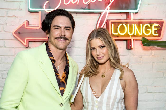 Tom and Ariana pose together for a photo at an event