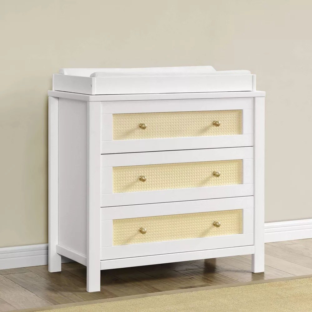 the white changing table and dresser