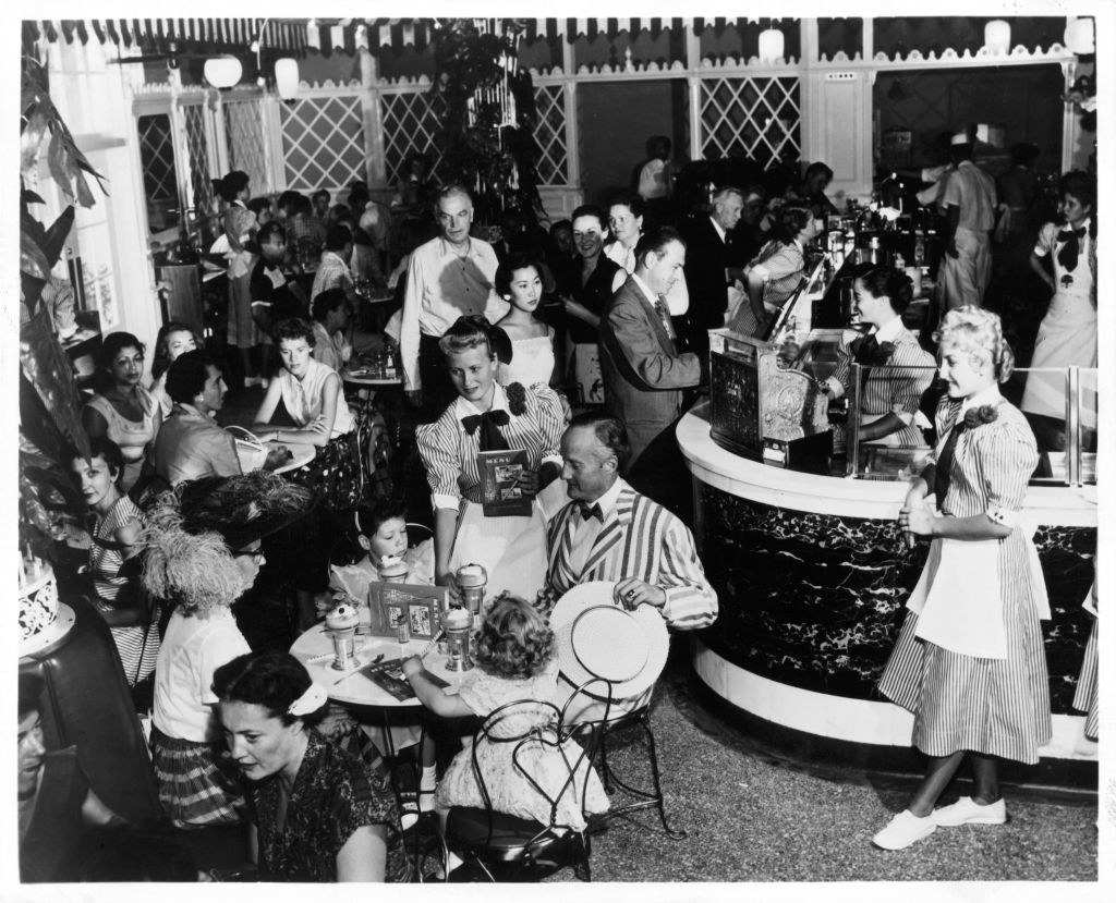 old photo of people eating at a cafe