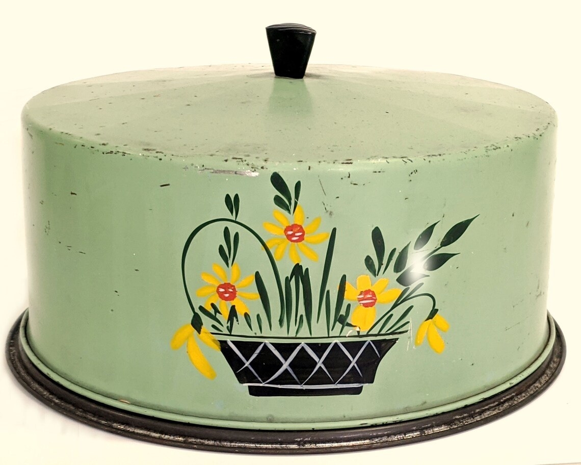 cake lid with a basket of flowers painted on it