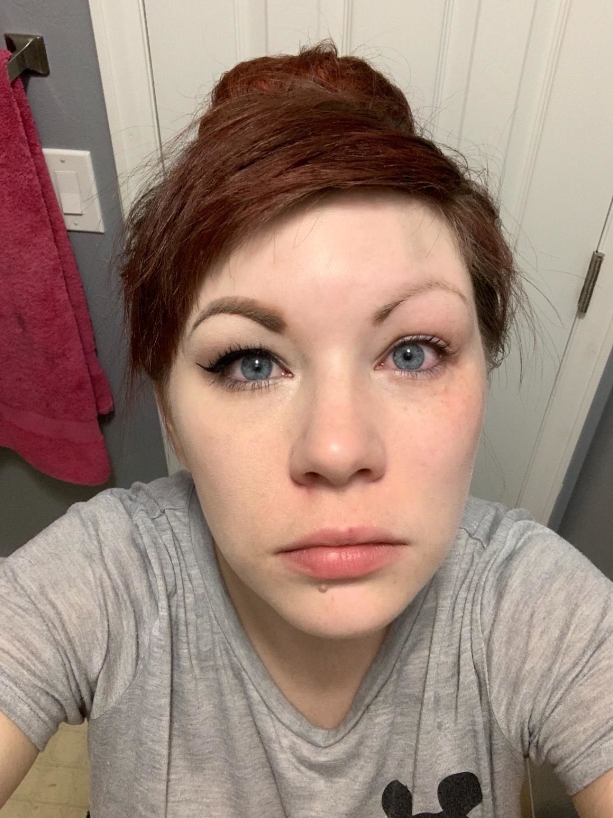 A reviewer with half their makeup removed