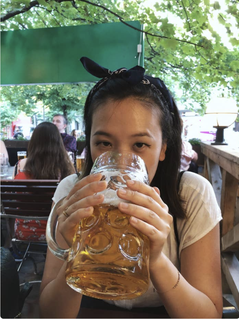 The writer drinking from a large beer mug
