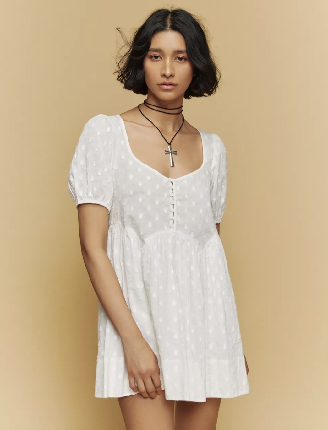 model wearing polka dot mini dress in white