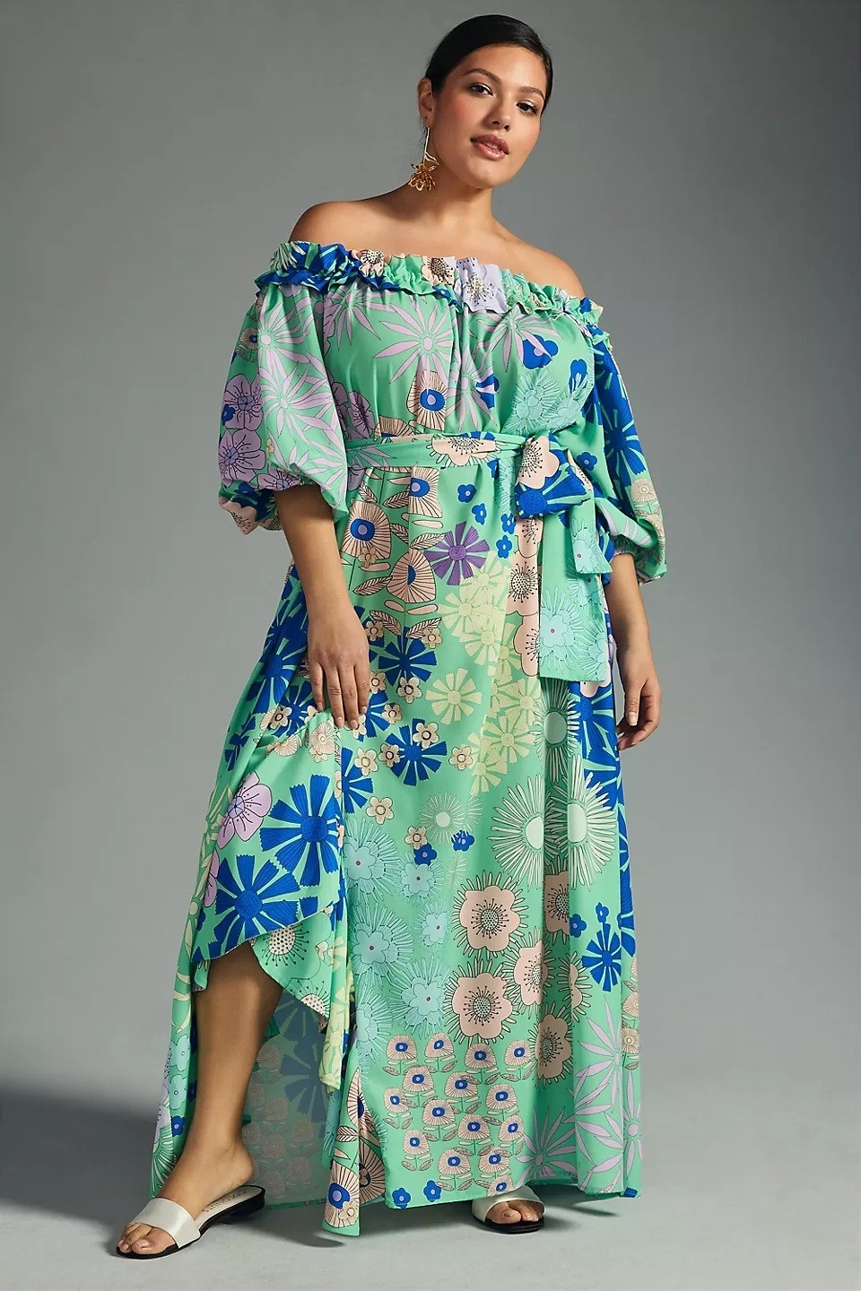 model wearing green and blue printed off-the-shoulder dress