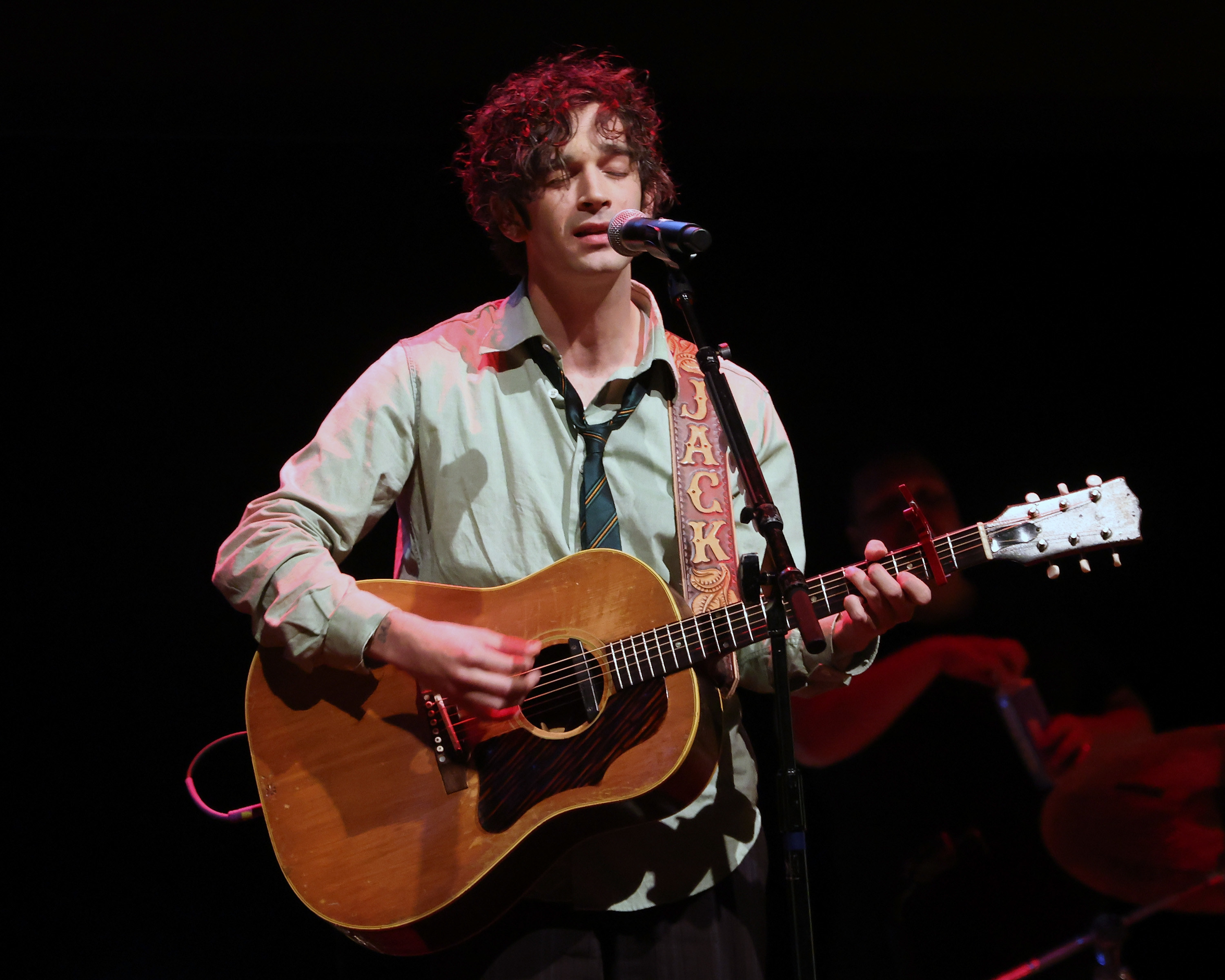 Matty onstage playing guitar