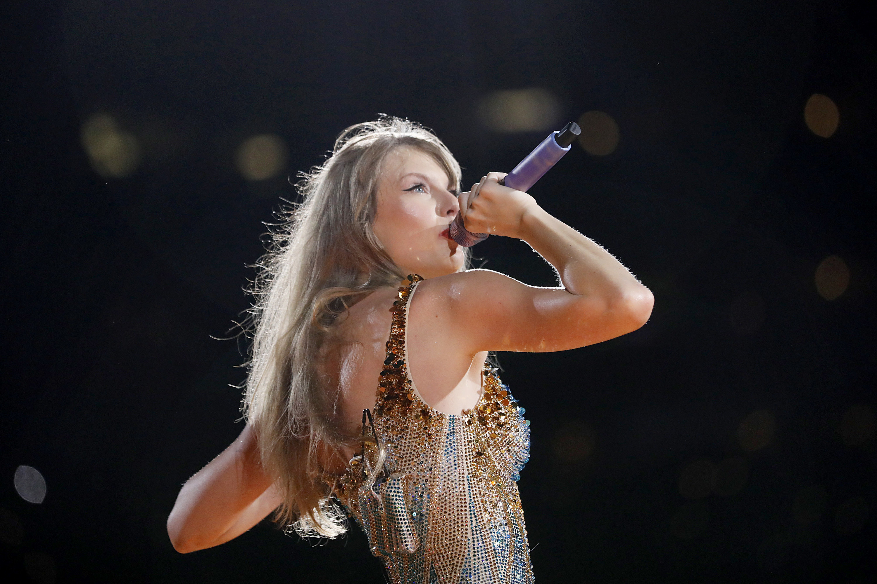 Close-up of Taylor performing onstage