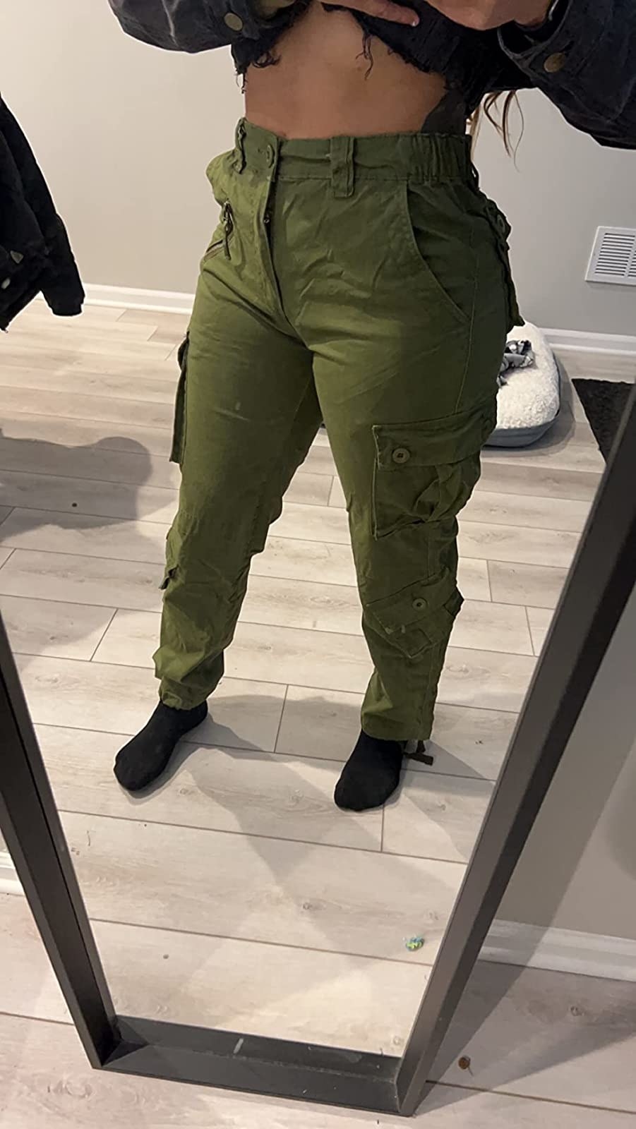 a reviewer wearing green pants with a black top
