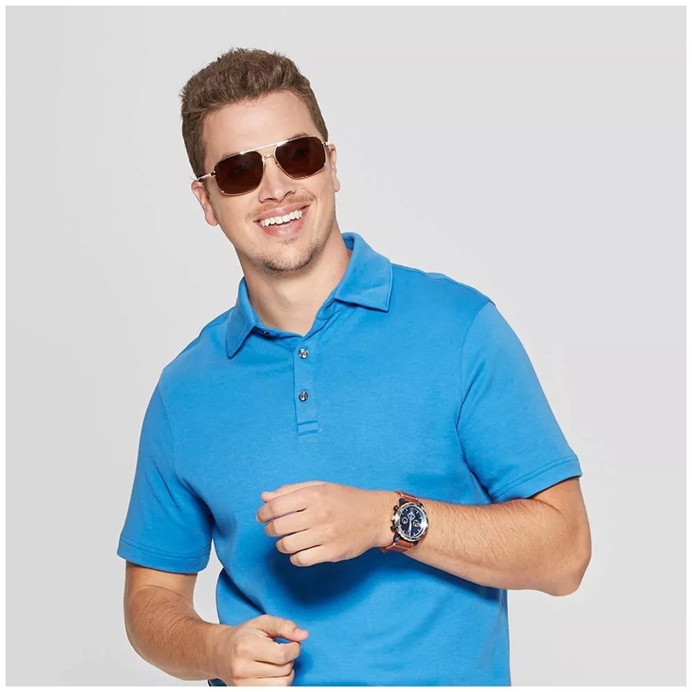 A model wearing a watch with a blue shirt