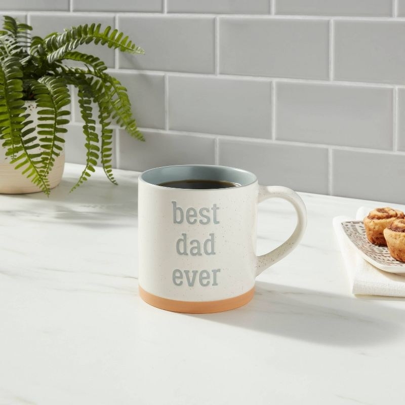A white mug that says best dad ever