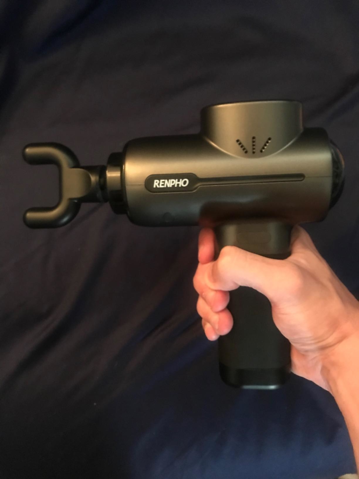 a reviewer holding the massage gun