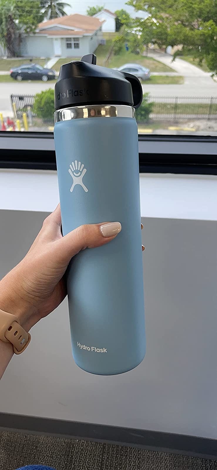 Reviewer&#x27;s blue water bottle with straw lid