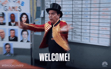 person dressed as a ringleader turning around and saying &quot;welcome!&quot;