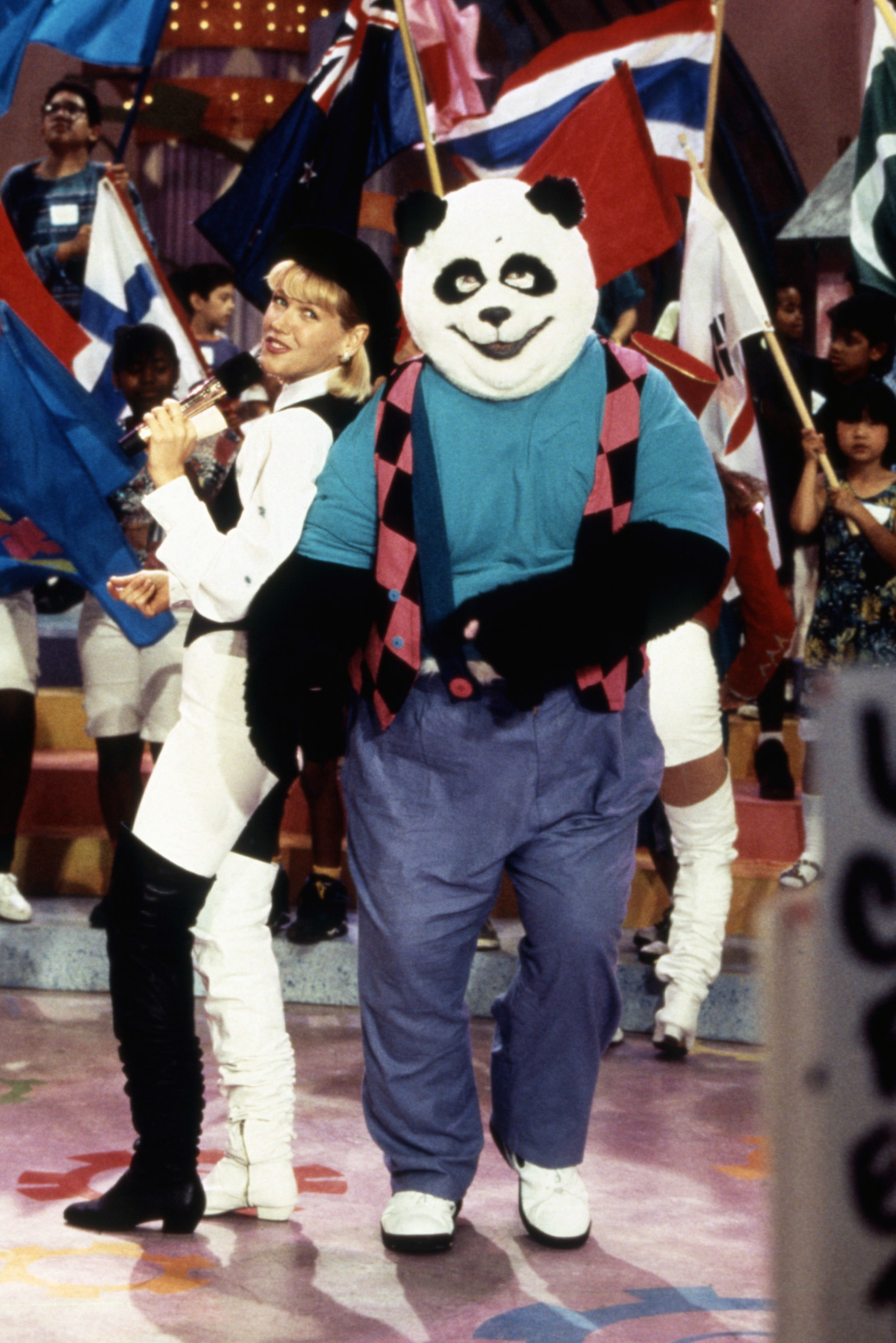 people dancing with a panda mascot