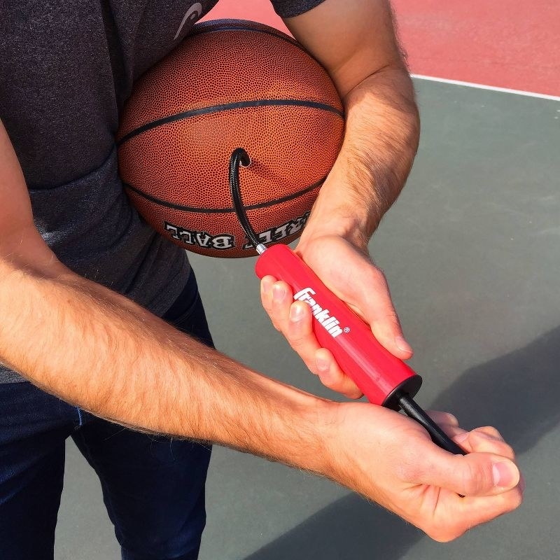 Model using the pump on a basketball