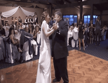 Dad dancing with newly married daughter