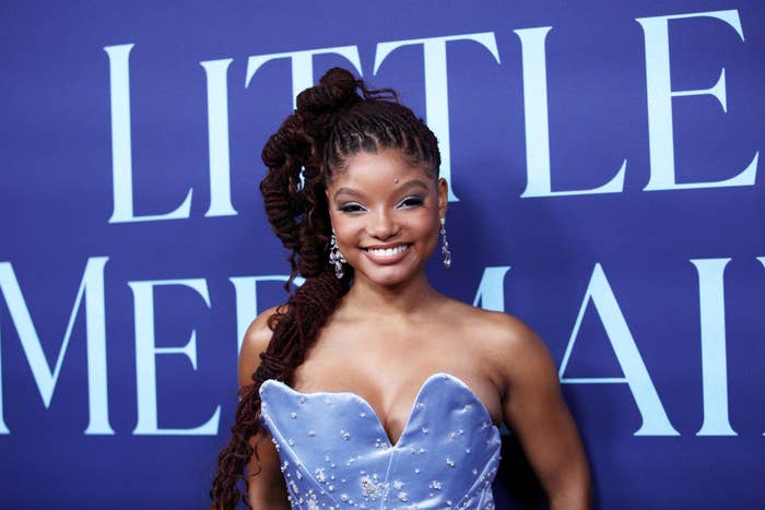 A closeup of Halle smiling on the red carpet. She&#x27;s wearing a strapless dress