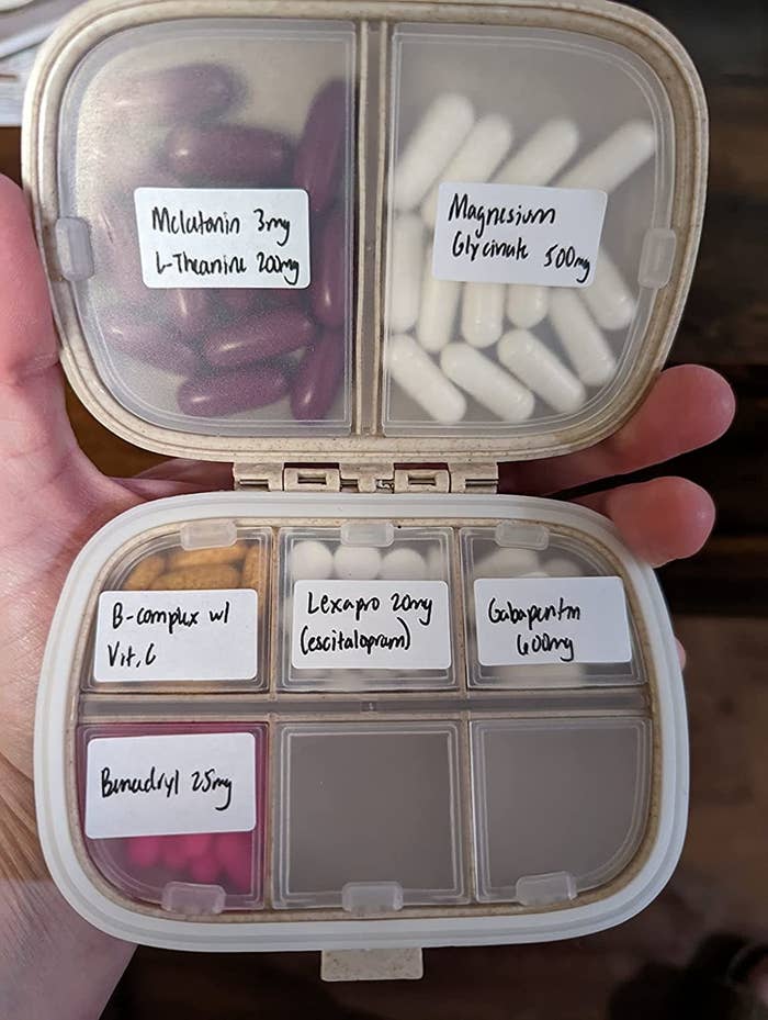 Reviewer holding labeled pill holder