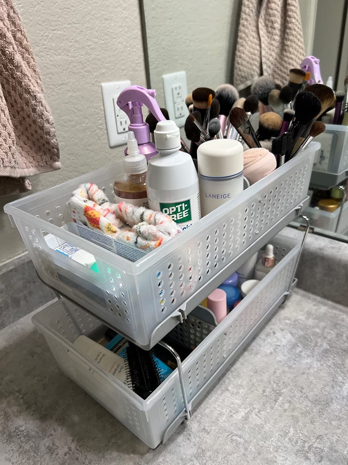Reviewer image of the organizer on a countertop filled with bathroom supplies