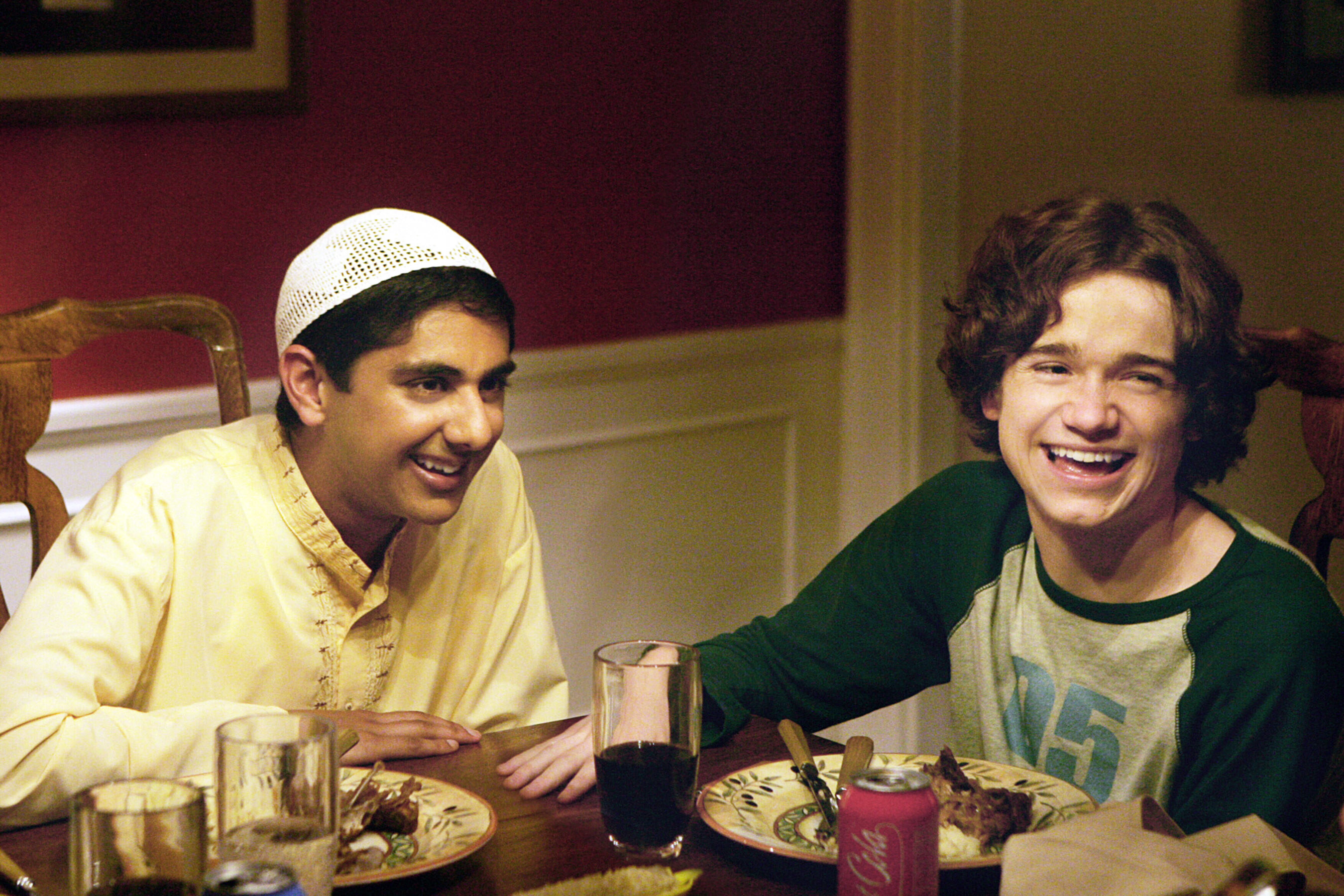 two teens sitting at the dinner table