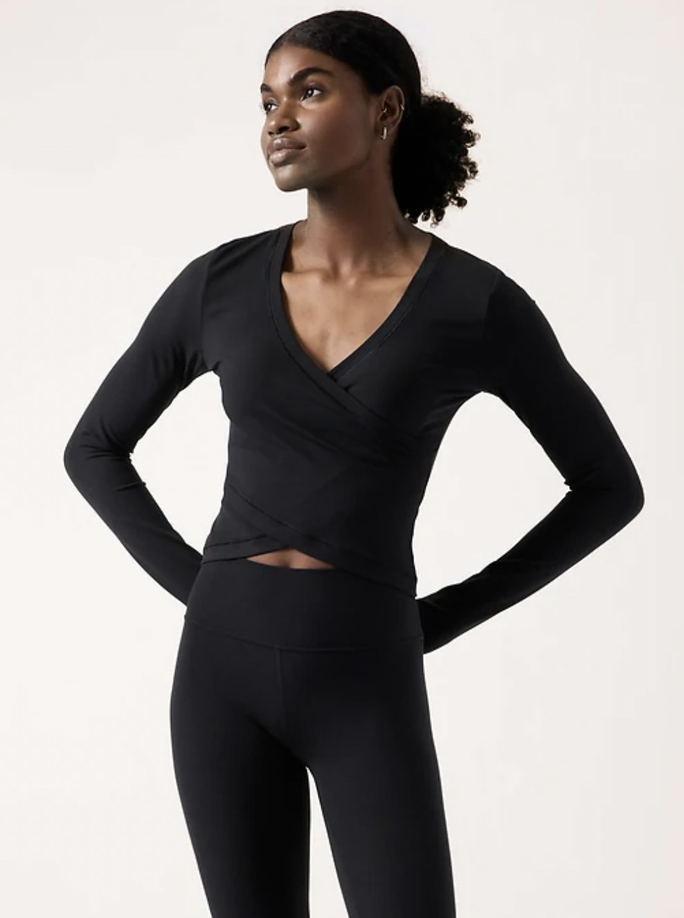 Model in the black wrap top with matching leggings