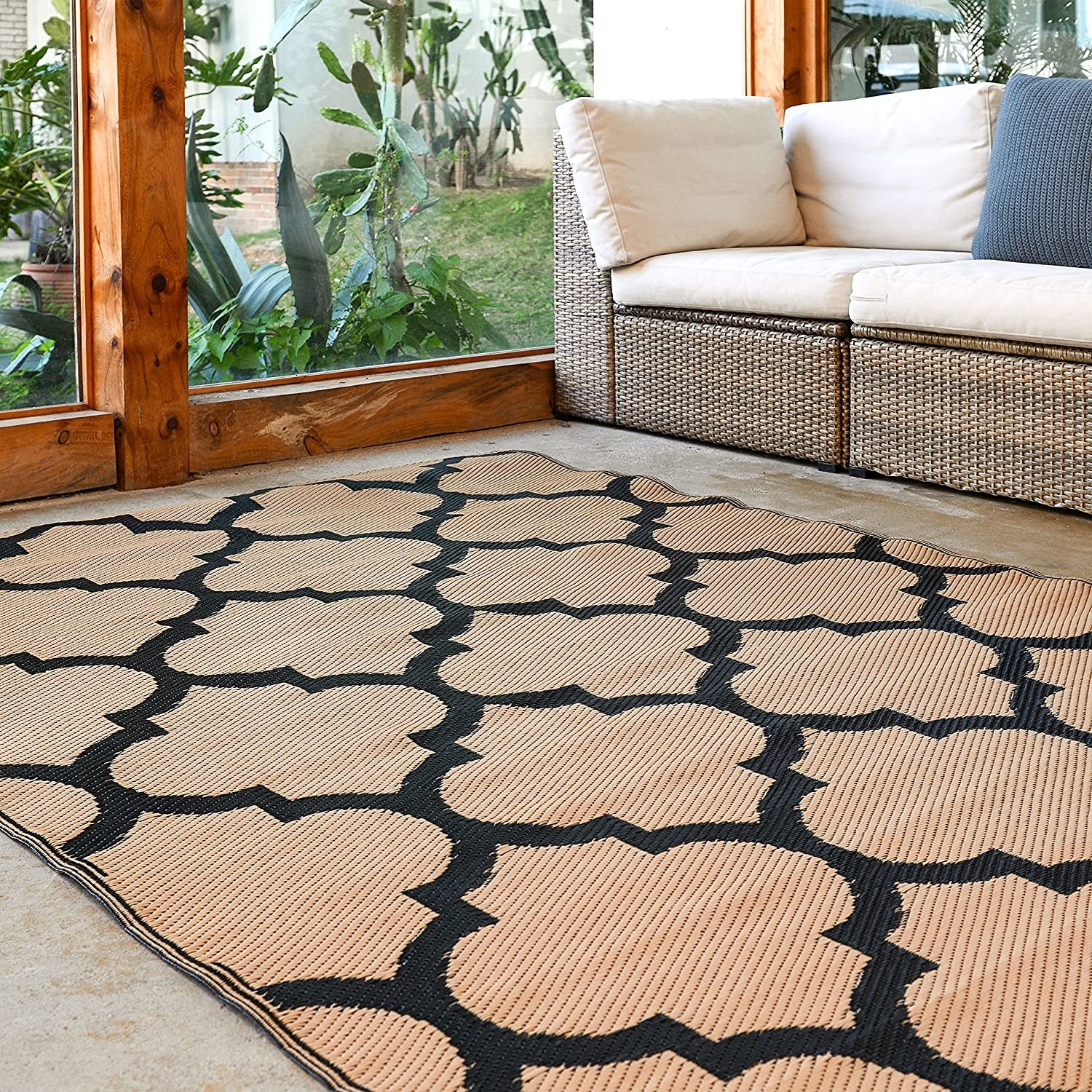 The rug on the ground in front of patio furniture