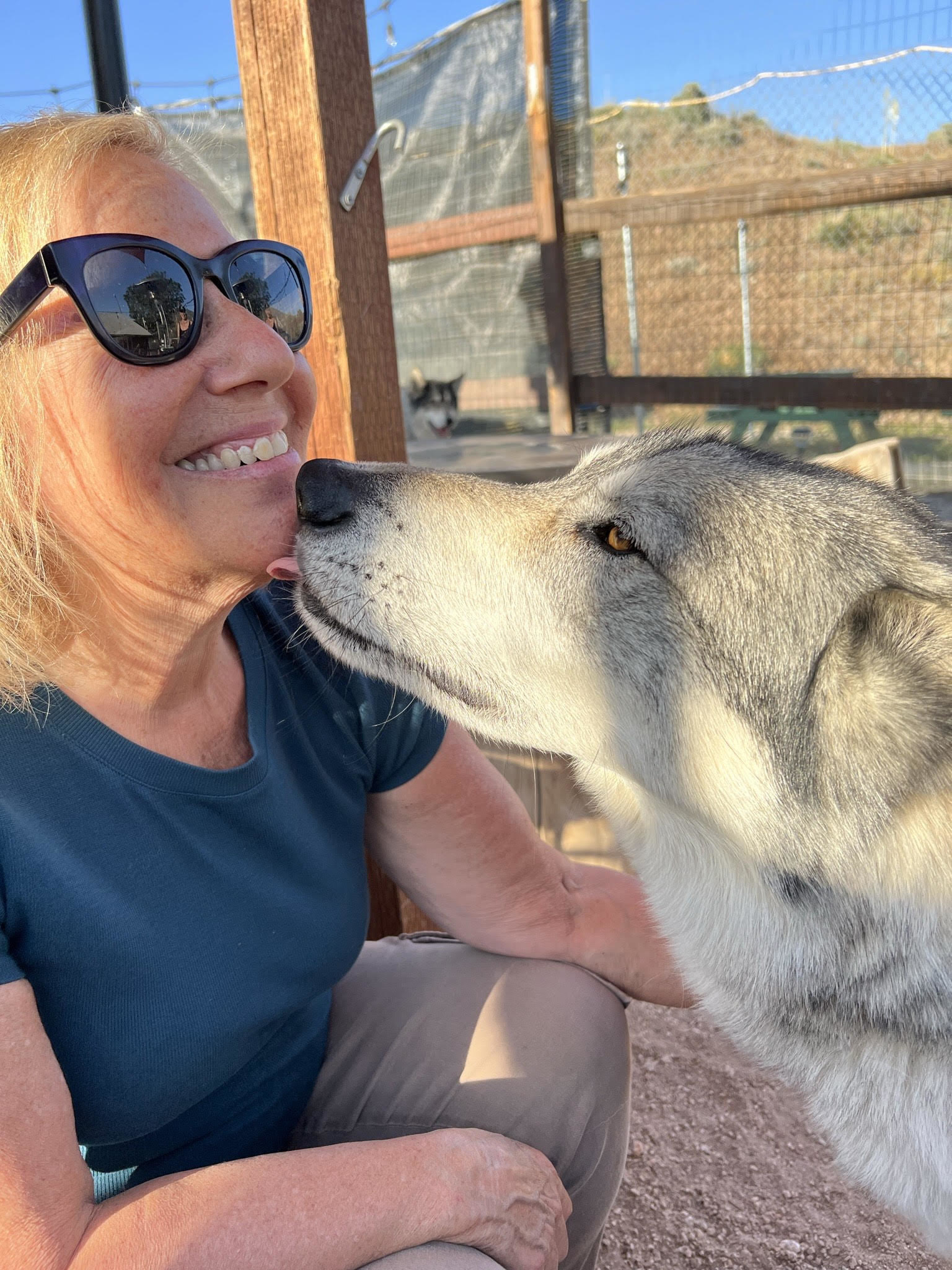 The writer&#x27;s mother smiles as a wolf licks her chin