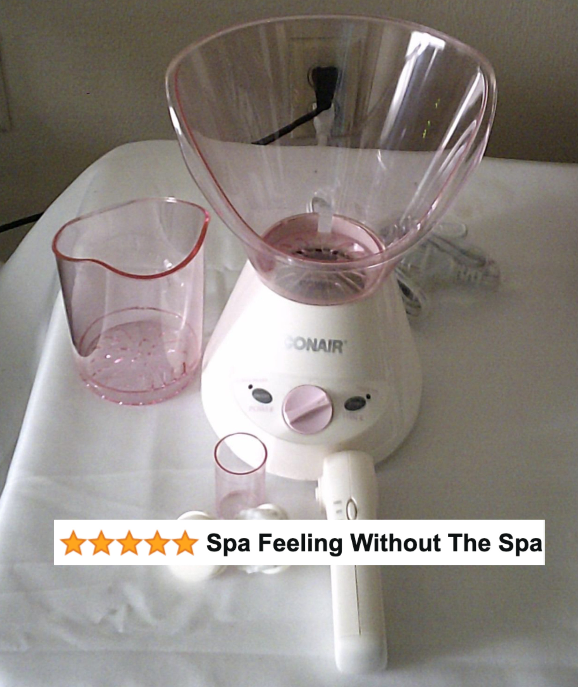 Facial steamer device on a table with a cup and rating stars, text &quot;Spa Feeling Without The Spa&quot; above