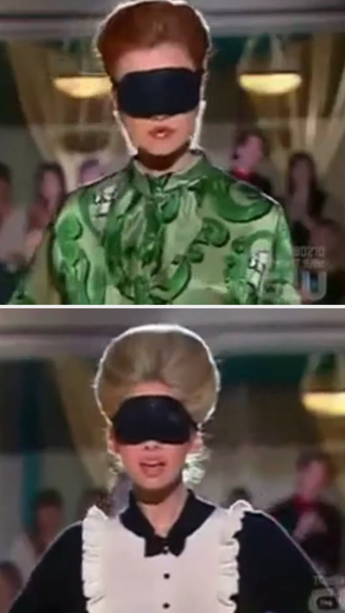 Two contestants walk down the runway blindfolded