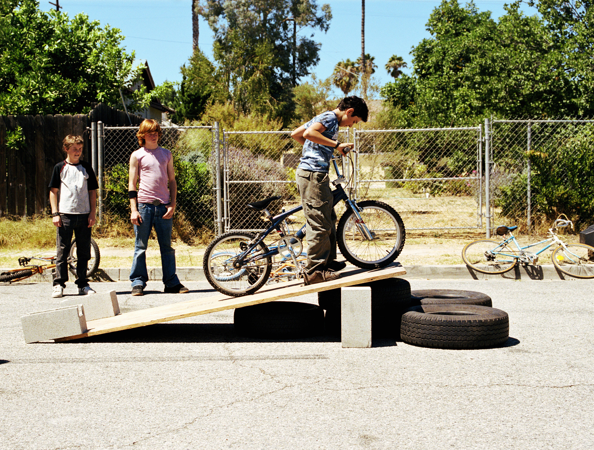 kids riding bikes on makeshift ramps