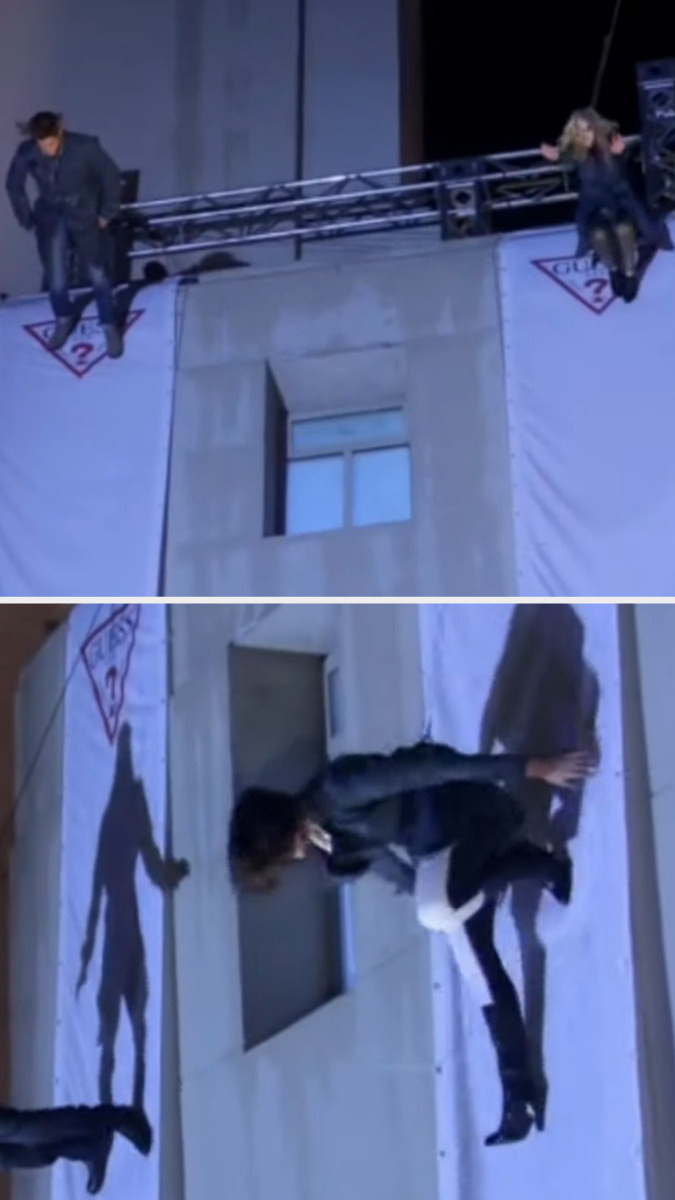 Contestants walk down the side of a building attached to a harness