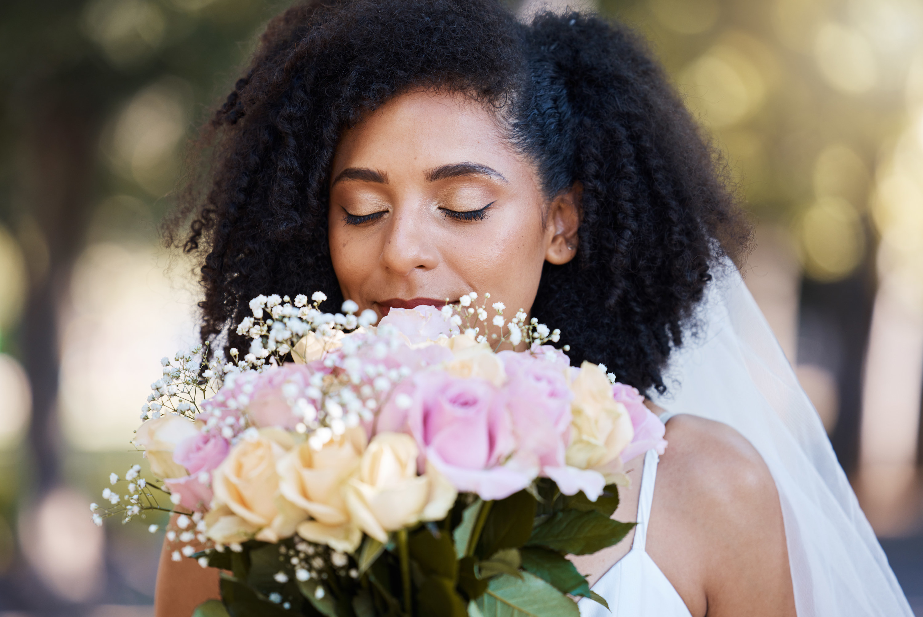 A bride smelling the flowers in her bouquet