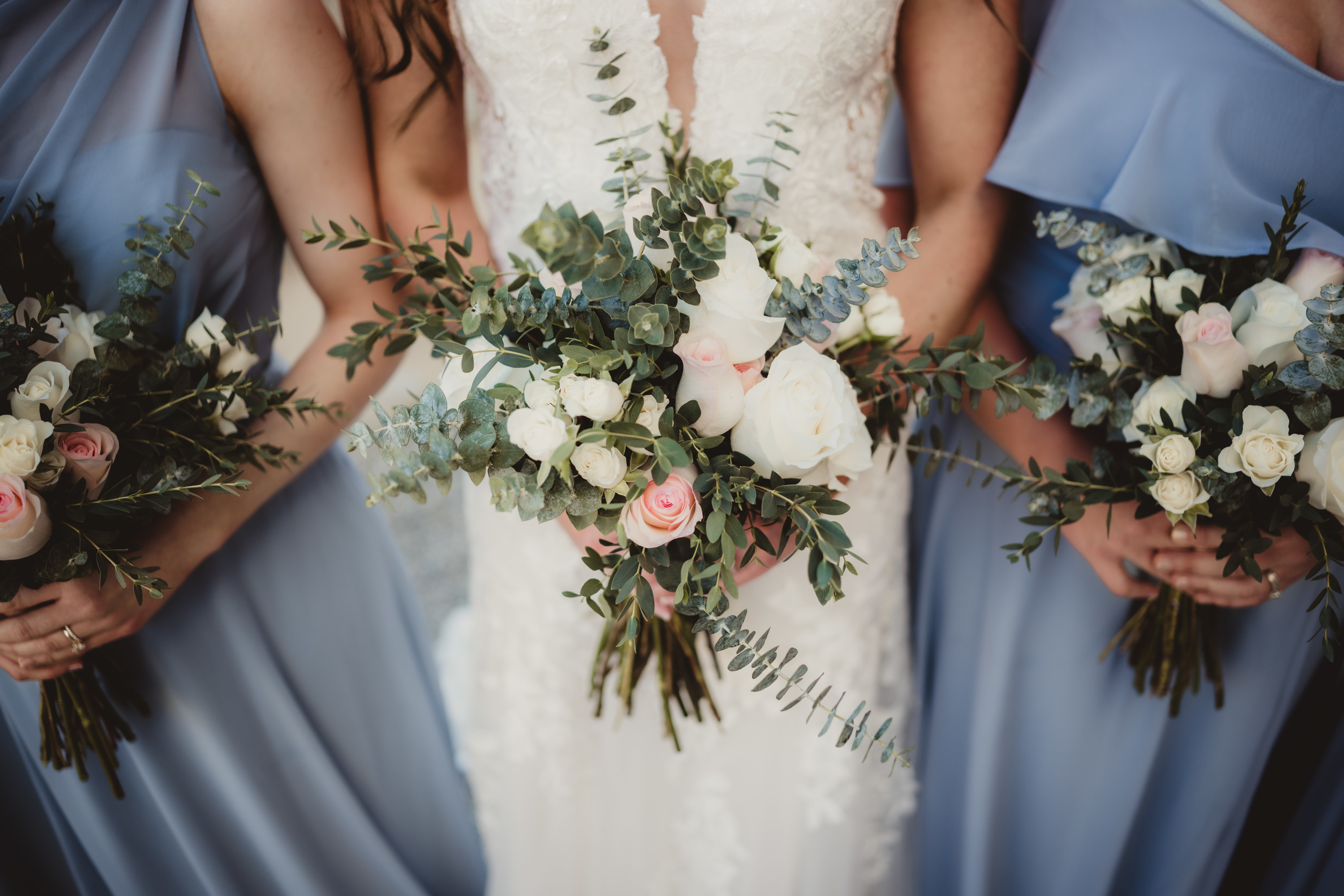 A bride and bridesmaids holding bouquets