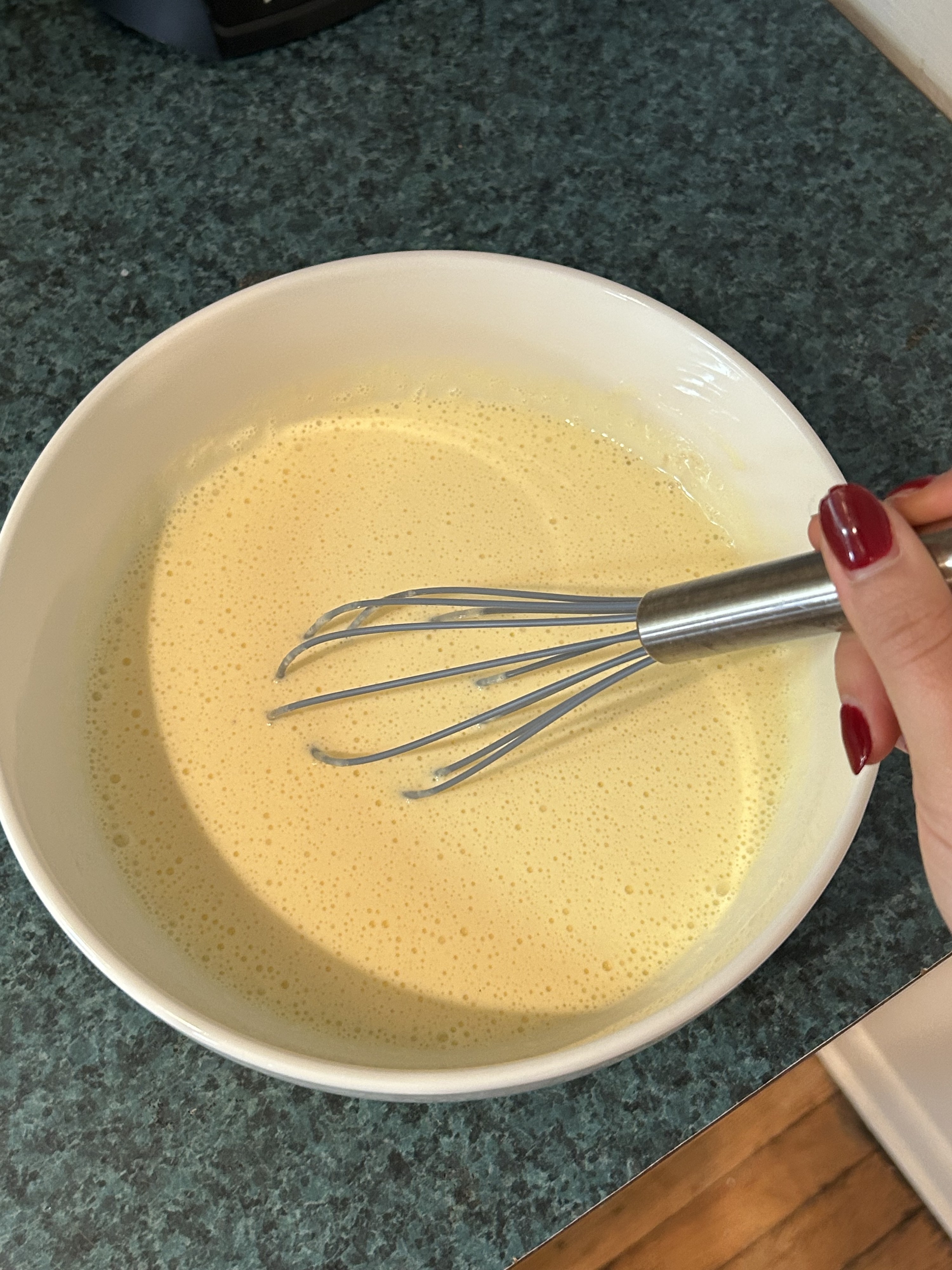 hand whisking the ingredients