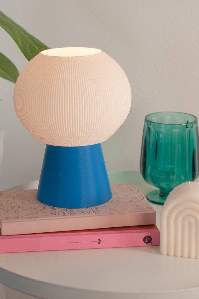 round textured lamp on a flared blue base