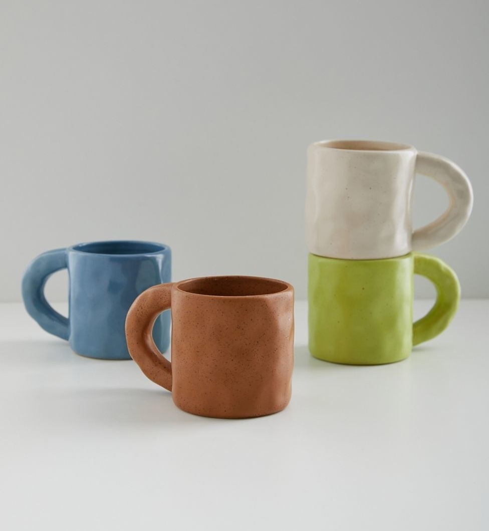 dimpled mug with a large chunky handle in orange, blue, lime green, and white