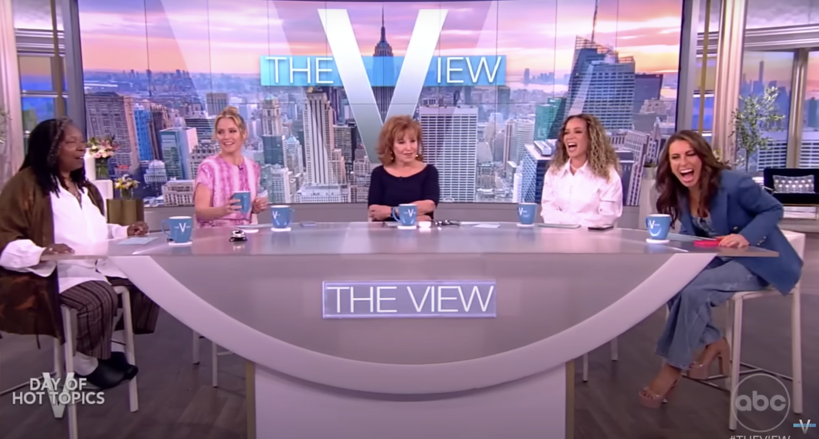 The ladies of the view laughing around a table