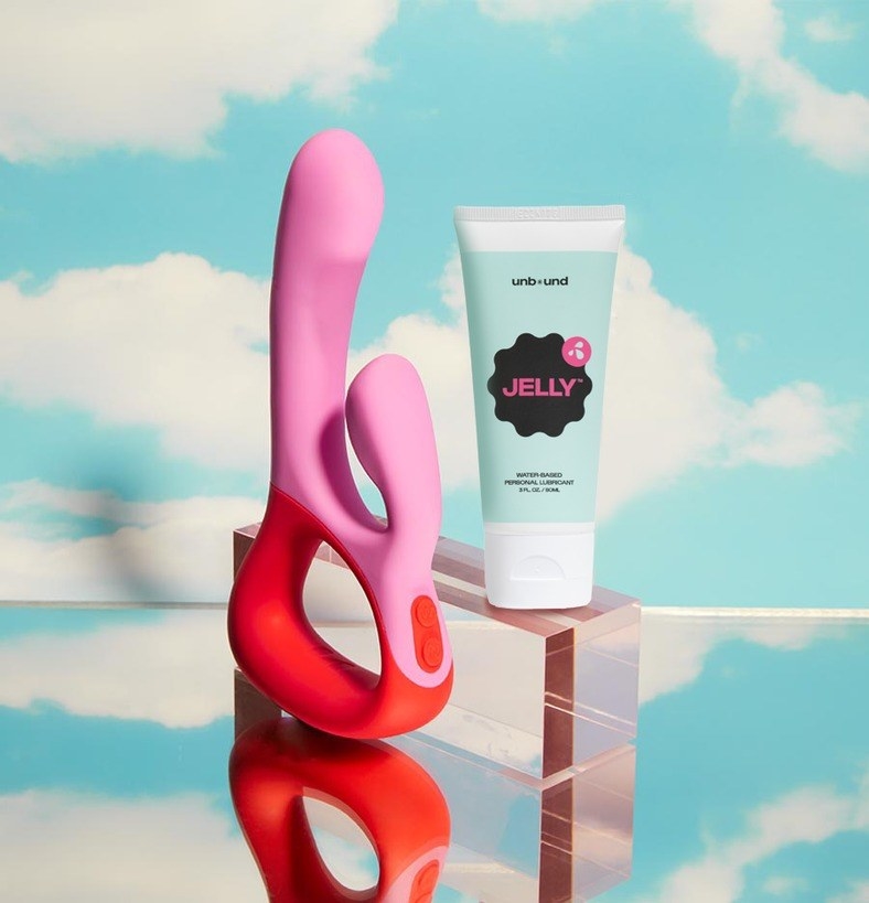 Pink and coral rabbit vibrator next to bottle of Jelly lubricant