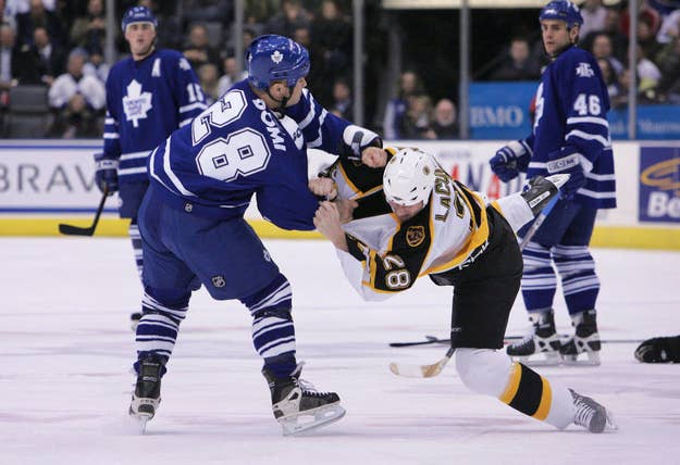 Tie Domi #28 of the Toronto Maple Leafs fights with Dan LaCouture #28 of the Boston Bruins