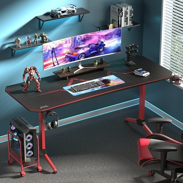Desk holds a computer and gaming equipment