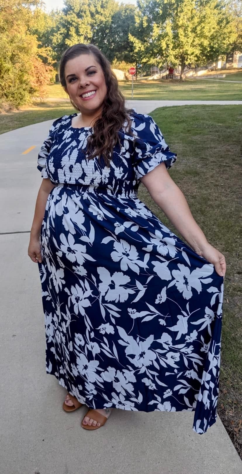 A reviewer in the white and navy floral maxi