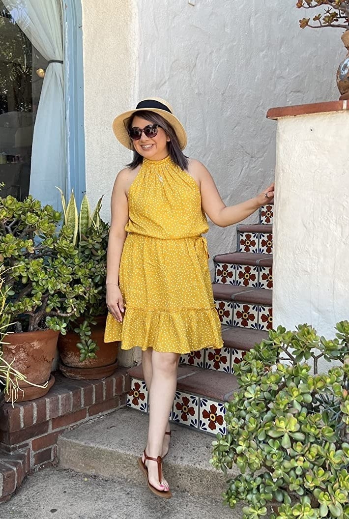 A reviewer  in the yellow polka dot dress