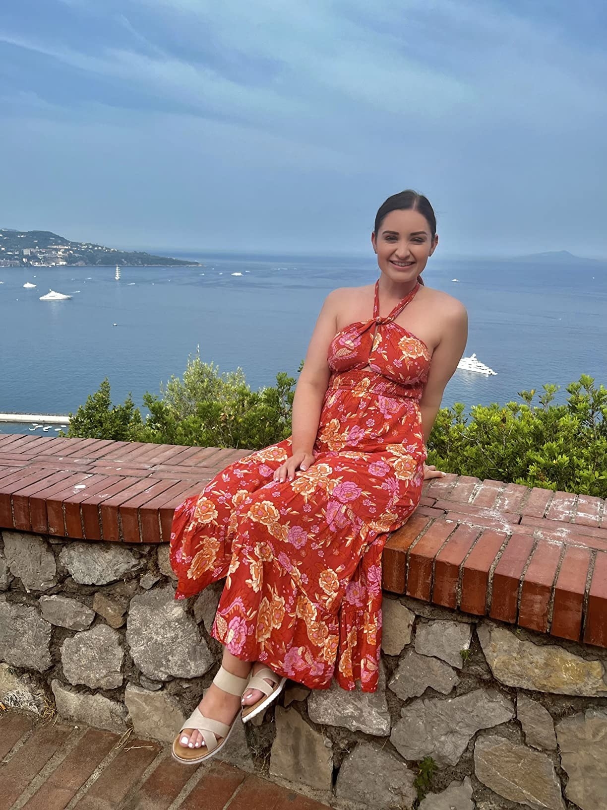 A reviewer in the red floral dress