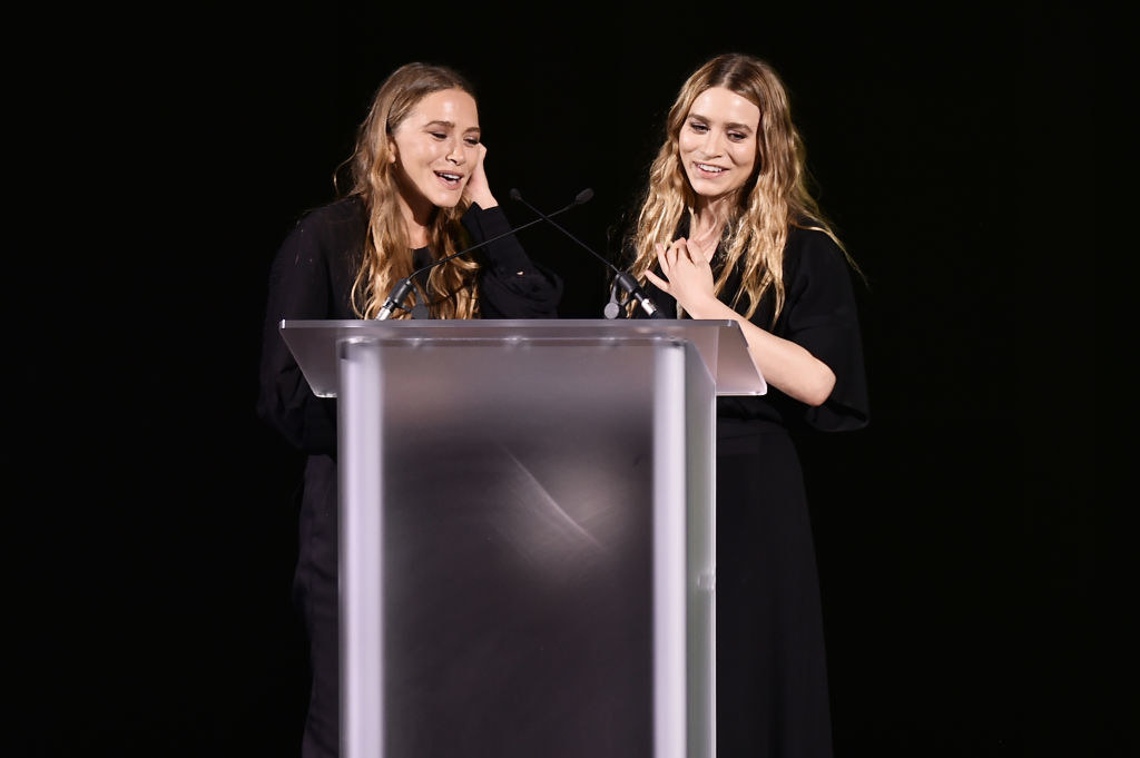 the twins speaking at a podium