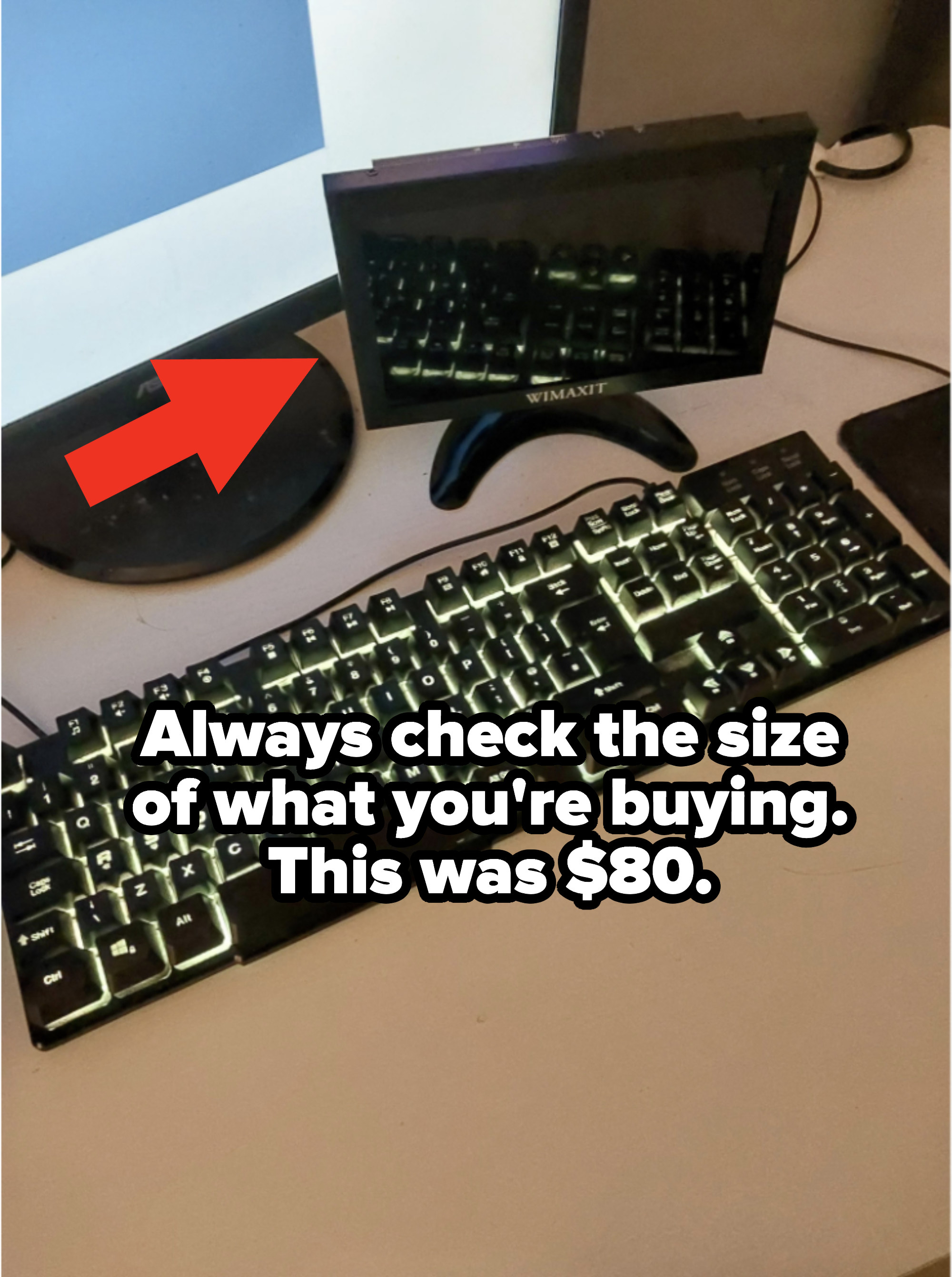 A tiny monitor next to a full-size keyboard