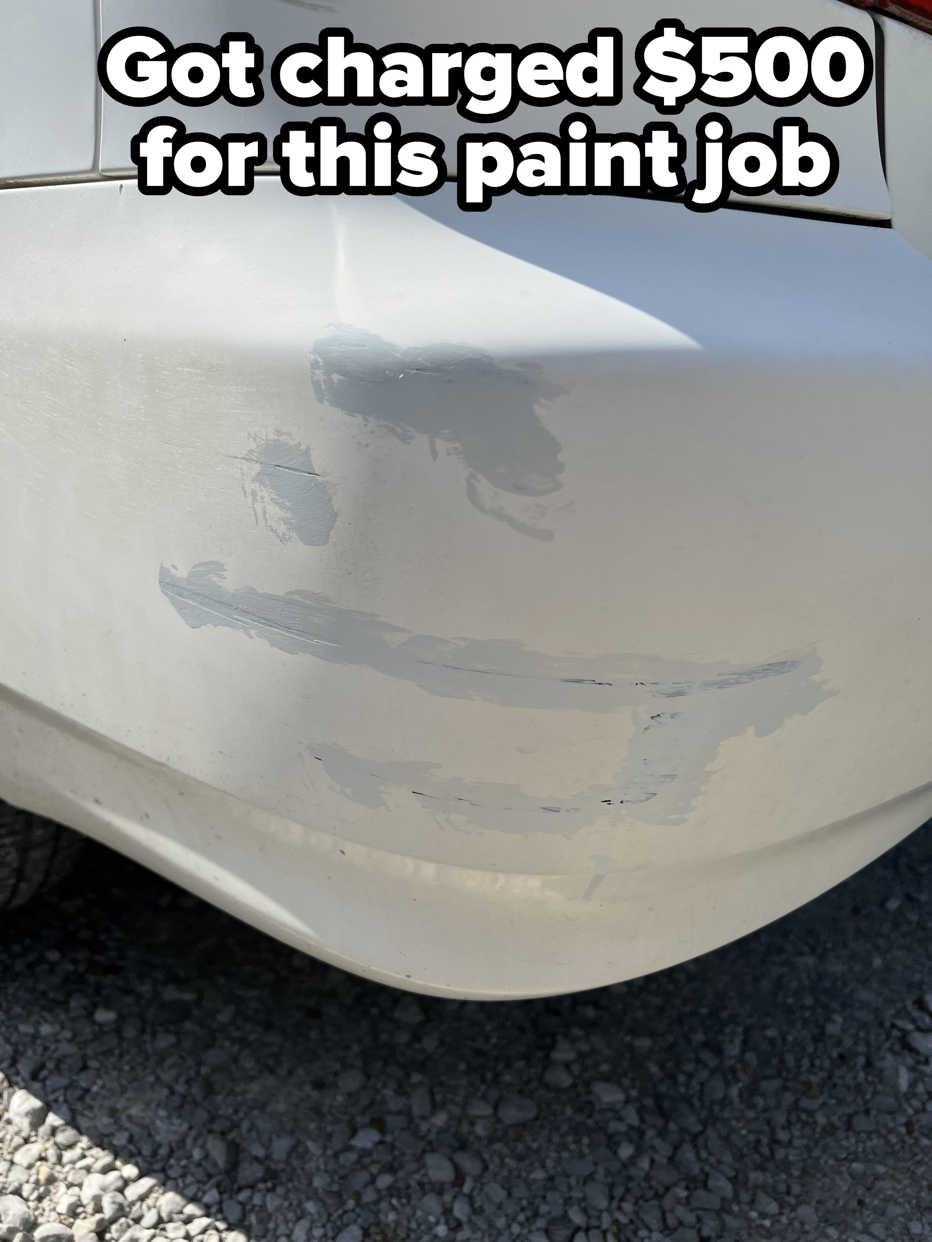 A white car with some gray-white smudges covering scrapes