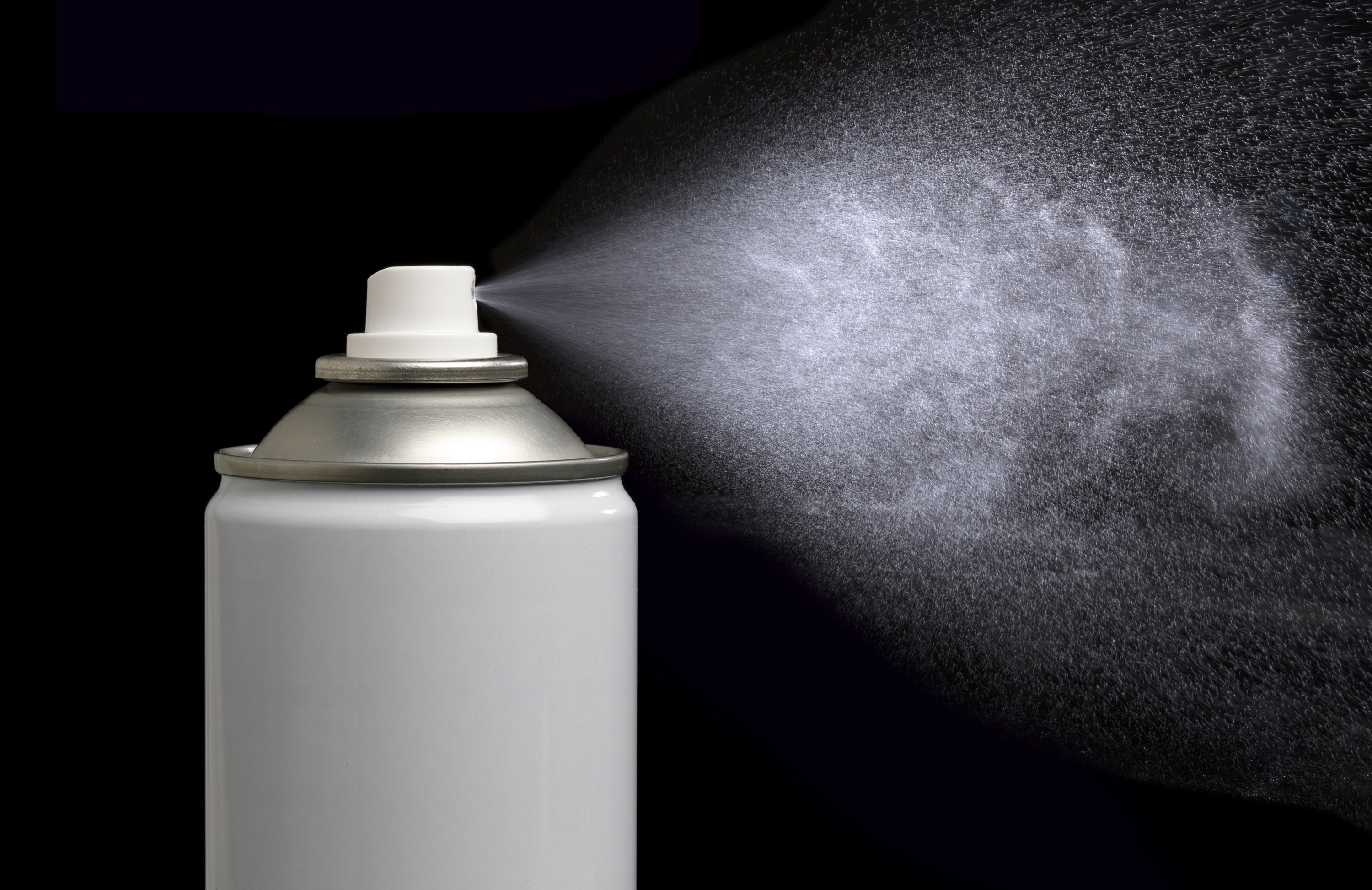 A spray can emitting a mist